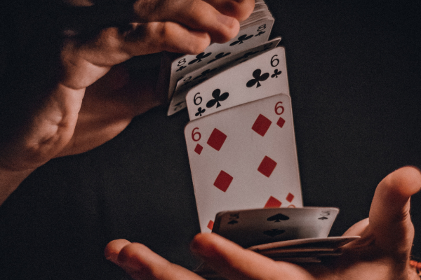 Photo shows a person shuffling a deck of cards