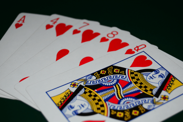 Photo shows five cards, all with the same suit