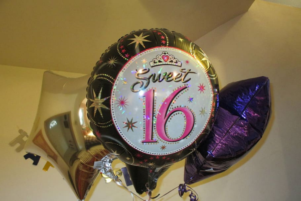 Balloons in various shapes and sizes for a sweet 16 party